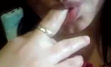 Dark-haired slut sucking on chubby fingers in POV